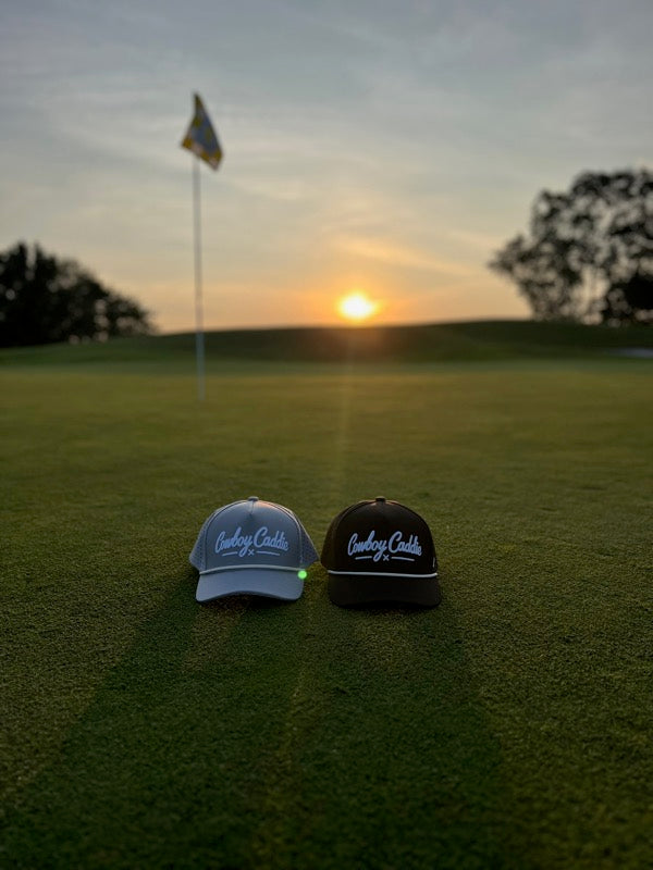 Cowboy Caddie hats on golf course at sunset
